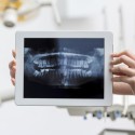 close-up-hands-holding-tablet-with-x-ray_23-2148396226